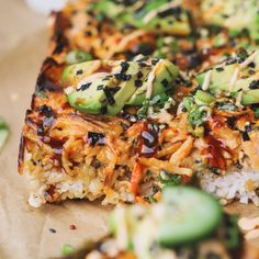 there is a slice of pizza with toppings on top of rice and cucumbers