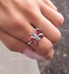 Garnet CZ butterfly silver ring, clear - Red - butterfly ring, silver ring, promise ring - 925 sterling silver Height: 16.0mm Width: 17.0mm Shank Width: 1.7mm Stone Material: Garnet CZ and White Cubic Zirconia Center Stone Size: 7.0mm x 5.0mm & 6.0mm x 4.0mm Stone Shape: Pear and Round Center Stone Carat Weight: 0.71 ct. & 0.39 ct. Number of CZ Stones: 8 Stone Setting: Prong Metal: 925 Sterling Silver Plating: Rhodium Finish: High Polish simply stunning. High Polished, solid 925 sterling silver. Rhodium plated to prevent tarnishing. TARNISH FREE Rhodium plated to avoid tarnishing Nothing but the best from my custom jewelry store. Email me if you have any questions. Elegant Cubic Zirconia Butterfly Ring, Silver Butterfly Fine Jewelry, Elegant Butterfly Ring Gift, Formal Butterfly-shaped Cubic Zirconia Rings, Diamond Butterfly Ring For Wedding, Fine Jewelry Butterfly Shape For Wedding, Butterfly-shaped White Gold Jewelry For Wedding, Fine Jewelry Butterfly Piece For Wedding, White Gold Butterfly Jewelry For Wedding