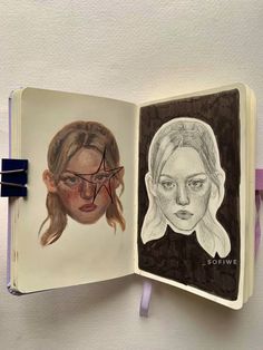 an open book with two drawings of women on it and one drawing of a woman's face