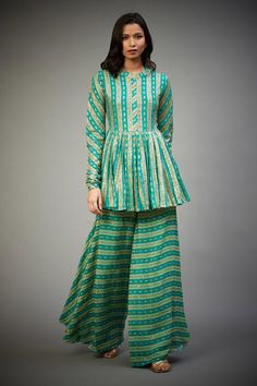 Emerald flared kurta with aari sequin embroidery and gathered sleeves. Paired with embroidered flared pant.
Component: 2
Pattern: Embroidered
Type Of Work: Aari Sequin Work
Neckline: Band
Sleeve Type: Full Sleeves
Fabric: Kurta and Pant-100% Rayon, Kurta Lining-100% Viscose
Color: Green
Other Details: 
Aari sequin work
Embroidered flared pant
Occasion: Wedding, Mehendi - Aza Fashions Anarkali Pant Set With Long Sleeve For Festivals, Anarkali Long Sleeve Pant Set For Festivals, Long Sleeve Block Print Sharara For Navratri, Fitted Block Print Sharara, Green Long Sleeve Sharara For Seasonal Transitions, Transitional Long Sleeve Green Sharara, Festive Green Bohemian Pant Set, Traditional Georgette Pant Set, Traditional Block Print Pants