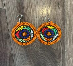 These gorgeous traditional beaded Zulu disc earrings are a gorgeous statement piece must haves.  Please note each piece is handmade and slight variations may occur. Flat Bracelet, Elephant Keychain, African Earrings, Beaded Flats, Recycled T Shirts, Disc Earrings, Top Handle Handbags, African Beads, Hanging Earrings