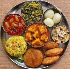 a metal plate topped with different types of food