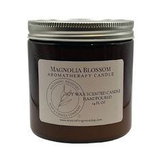 a candle that is sitting in front of a white background with the words, magnolia blossom aroma