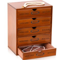 a wooden jewelry box with five drawers