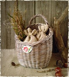 a wicker basket filled with dried flowers on top of a table