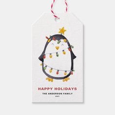 a penguin christmas ornament hanging from a string