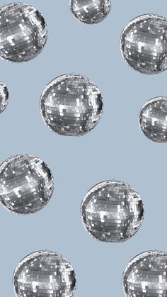 silver disco balls on a light blue background