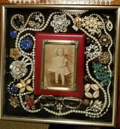 an old fashion picture frame is adorned with pearls, beads and other things to decorate it