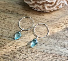 Dainty little aquamarine faceted crystal gemstone hoop earrings in 20mm sterling silver or 14k gold filled hoops. Option for gold plated and silver plated are less expensive. Please see drop down. Perfect for March birthdays! 💙Aquamarine, a stone of serenity, calms and soothes with it's lovely blue/green color and evokes the calm of the water with it's given name, which is interpreted at 'water of the sea' derived from Latin. A stone that celebrates the sea goddess of ancient times, it was carr Aquamarine Hoop Earrings, Blue Nickel-free Small Hoop Earrings, Nickel Free Blue Aquamarine Earrings, Silver Aquamarine Gemstone Earrings, Elegant Aquamarine Nickel-free Earrings, Blue Gemstone Earrings, Raw Stone Earring, Gemstone Hoop Earrings, Gold Filled Hoops