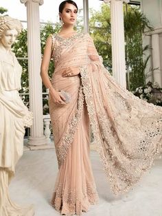 <p><strong>Top:<br /></strong>Color: Champagne<br />Fabric: Tissue Silk<br />Blouse adorned beautifully with exquisite embellishments accent the neckline<br />Stunning beads and pearls scattered all over<br />Dangling pearls on armhole and hemline<br />Round neckline<br />Fully lined<br />Hidden back hooks closure<br />Hemming finished<br /><br /><strong>Saree:<br /></strong>Color: Champagne<br />Fabric: Crinkle Chiffon<br />Comes with saree features flourshing embellishments and cut work on pal Hand Embellished Organza Saree For Wedding, Wedding Organza Saree Hand Embellished, Wedding Hand Embellished Organza Saree, Elegant Organza Wedding Dress With Traditional Drape, Elegant Hand Embellished Wedding Dress With Traditional Drape, Glamorous Georgette Dupatta For Wedding, Glamorous Embellished Wedding Dupatta, Embellished Wedding Dress With Traditional Drape, Elegant Wedding Saree With Pearl Embroidery