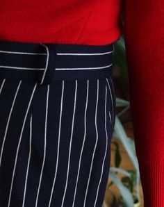 Beautiful vintage skirt made of pure wool. Long, midi high waisted cut. Navy blue color with pattern of white pinstripes. Zipper and button closure, belt loops. Row of buttons on the front. Lined. Era: 80's, Italy Fabric: 100% wool Condition: perfect, looks unworn Estimated size: L / XL (please, check the measurements) Measurements (measured flat): Waist: 42 cm / 16,5 inches Length: 68 cm / 26,7 inches Red turtleneck sweater available here: https://www.etsy.com/listing/214804600/80s-italian-red- Striped Midi Skirt For Work, Striped Lined Skirt For Workwear, Striped Lined Skirt Bottoms For Workwear, Chic Pinstripe Skirt For Work, Pinstripe Vertical Stripes Skirt For Work, Vintage Striped Bottoms For Workwear, Striped Fitted Midi Skirt, Navy Pleated Skirt For Workwear, Navy Pleated Skirt Bottoms For Workwear