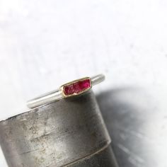 My newest stackable ring features a lovely rectangular raw ruby crystal in a deep red color. Set in rich yellow gold atop a brushed silver band to bring out contrast. I fabricated this simple design from sterling silver and 22k yellow gold. The rough gemstone is all natural and displays darkness and light. Weight: 0.55ct Measurement: 6.5x3mm Ring shank measures 2x2mm. Size 5.5 or 50.5 or 16 or K 1/2 nangijalajewelry.etsy.com One Of A Kind Fine Jewelry Ruby Rings With Rectangular Stone, Ruby Gemstone Stackable Rings As Gift, Rectangular Ruby Ring In Fine Jewelry Style, Rectangular Gold Ruby Ring As Gift, Ruby Ring With Rectangular Stone For Anniversary, Anniversary Ruby Ring With Rectangular Stone, Fine Jewelry Ruby Ring With Rectangular Stone, Rectangular Ruby Ring For Anniversary, Ruby Gemstone Rings With Rectangular Stone