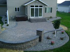 a brick patio in front of a house