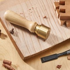 a wooden cutting board with some wood shaving tools on it