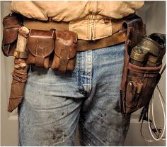 a man wearing a leather belt and holding his tool belt