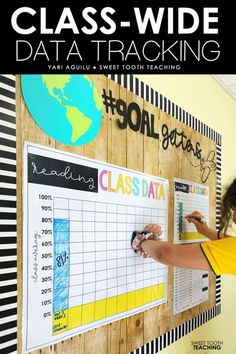 a girl writing on a bulletin board with the words class - wide data tracking