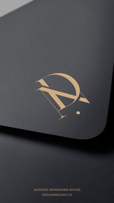 the monograma design logo is shown on top of a black envelope with gold foil