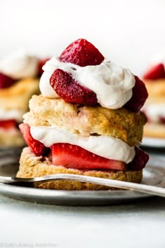 strawberry shortcakes with whipped cream and fresh strawberries on top are ready to be eaten