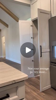 an empty kitchen with stainless steel appliances and white cabinetry is featured in this video