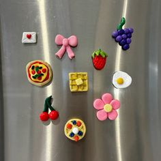 some food is laying on top of a stainless steel refrigerator door with magnets attached to it