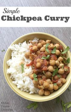 a bowl filled with rice and chickpea curry on top of a wooden table