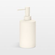 a white soap dispenser sitting on top of a table