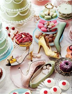 a table topped with lots of cakes and desserts