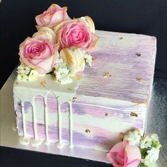 a cake decorated with pink and white flowers