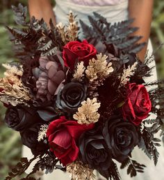 a bridal bouquet with red and black flowers