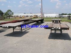 several picnic tables and benches in an empty lot