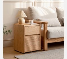 a wooden table with a cup on it next to a white couch and beige rug