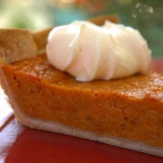 a slice of pumpkin pie with whipped cream on top