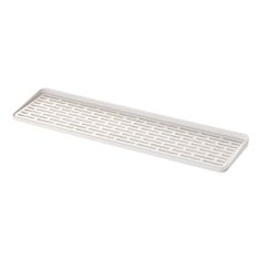 a white tray with holes on the bottom is shown in front of a white background