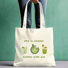 Elevate your everyday style with our  everyday tote bag for matcha lovers! Made from durable, eco-friendly materials, this charming tote is perfect for carrying your essentials in a fun and stylish way.  If you love traveling to Japan, love their culture, or just want a minimalist tote bag, this is for you.  Whether you're a traveler, a busy student, or a grocery shopper, this tote adds a dash of positivity to your day. Perfect for matcha enthusiasts, eco-conscious shoppers, and stylish students Green Kawaii Shoulder Bag For Daily Use, Kawaii Green Shoulder Bag For Daily Use, Green Canvas Bag With Letter Print For Everyday, Eco-friendly Green Bag With Letter Print, Eco-friendly Green Bags With Letter Print, Aesthetic Matcha Latte, Japanese Kawaii Fashion, Aesthetic Matcha, Traveling To Japan