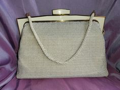 Step back in time with this elegant vintage Glomesh bag from the 1960s. This stunning white handbag exudes timeless charm and sophistication, making it a perfect accessory for any classic wardrobe. Features: Brand: Glomesh Color: Off White (not a bright white) Condition: Used, but in good condition Material: Mesh Details: Classic design, sturdy frame, secure clasp, lined interior Era: 1960s Measurements: Height: 17cm Width: 24cm Strap Drop: Notes: Very minor signs of wear on the clasp, consistent with age, but overall well-maintained.  Clean interior with no major stains or odors.Functional clasp and hardware. This Glomesh bag is perfect for collectors, vintage enthusiasts, or anyone looking to add a touch of retro glamour to their outfit. Don't miss the chance to own a piece of fashion hi Elegant White Evening Bag For Vintage Events, White Retro Formal Bags, Vintage White Party Bags, Retro White Formal Bags, Retro White Formal Bag, Vintage White Shoulder Bag, White Vintage Party Bag, Vintage White Evening Bag For Events, Vintage White Rectangular Bag