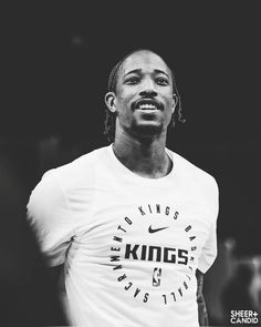 a black and white photo of a man in a t - shirt with the words kings on it