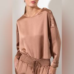 Make A Major Luxe Lounge Statement With The Brochu Walker Dallas Satin Blouse. In A Beautiful Recycled Satin-Finish Fabric, Its Boxy, Pullover Silhouette Is As Fluid As It Is Modern. With A Signature Shoulder-Button Closure That Allows You To Wear It Closed As A Boatneck Or Open And Off The Shoulder, It Is The Ultimate In Versatility And Elegance. Boxy, Pullover Silhouette Hits Mid Hip Boatneck With Button Closure Along One Shoulder Straight Sleeves With Turn-Back Cuffs Two On-Seam Pockets 24.5 Chic Blouse With Button Closure For Loungewear, Chic Loungewear Blouse With Button Cuffs, Chic Blouse With Buttons For Loungewear, Elegant Button-up Tops For Loungewear, Long Sleeve Loungewear Blouse With Buttons, Long Sleeve Blouse For Loungewear, Long Sleeve Blouse For Loungewear With Buttons, Luxe Lounge, Satin Color