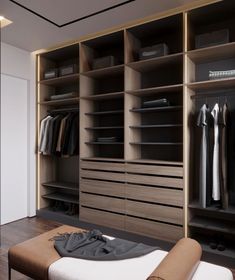 a large walk in closet with clothes on shelves