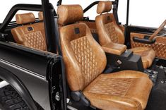 the interior of a vehicle with brown leather seats