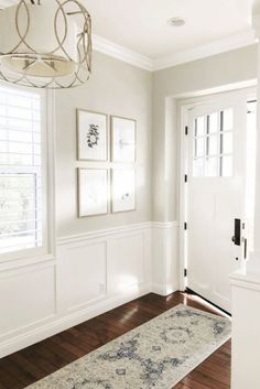 a hallway with white walls and wood floors