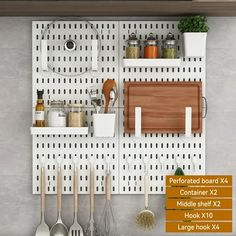 the peg board is hanging on the wall with utensils and other kitchen items