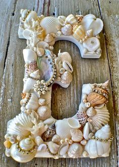 the letter e is made out of seashells and pearls