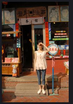 a woman standing in front of a store