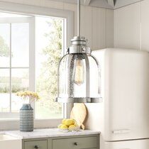 a white refrigerator freezer sitting inside of a kitchen next to a sink and window