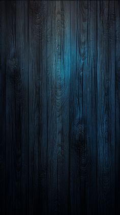 a dark wood background with some light shining on it