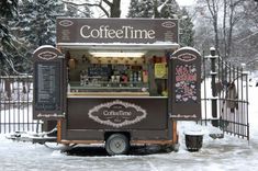 an ice cream cart is parked in the snow