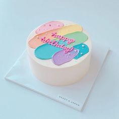 a birthday cake that is on top of a white plate with the words happy birthday written on it