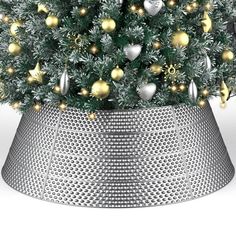 a christmas tree in a metal pot with lights on it's sides and ornaments all over the top