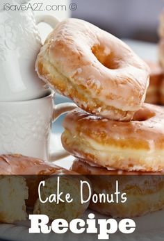 three glazed donuts stacked on top of each other next to a cup of coffee