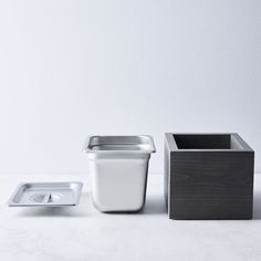 two square containers and one rectangular container on a table